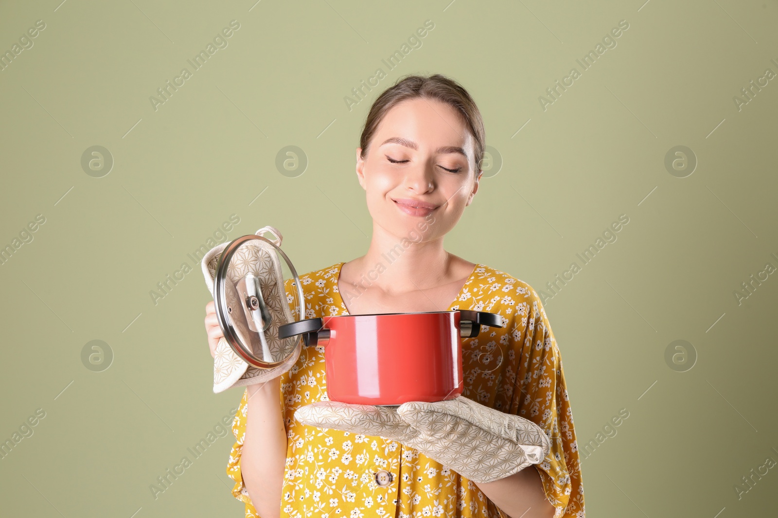 Photo of Happy woman with pot on olive background