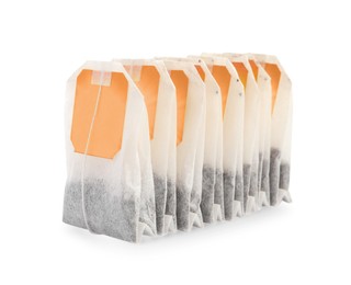 Photo of Many new tea bags on white background