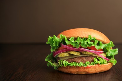 One tasty burger on wooden table. Space for text