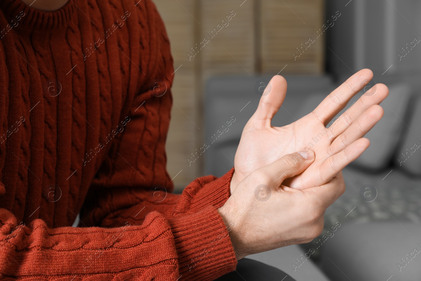 Photo of Man suffering from trigger finger at home, closeup
