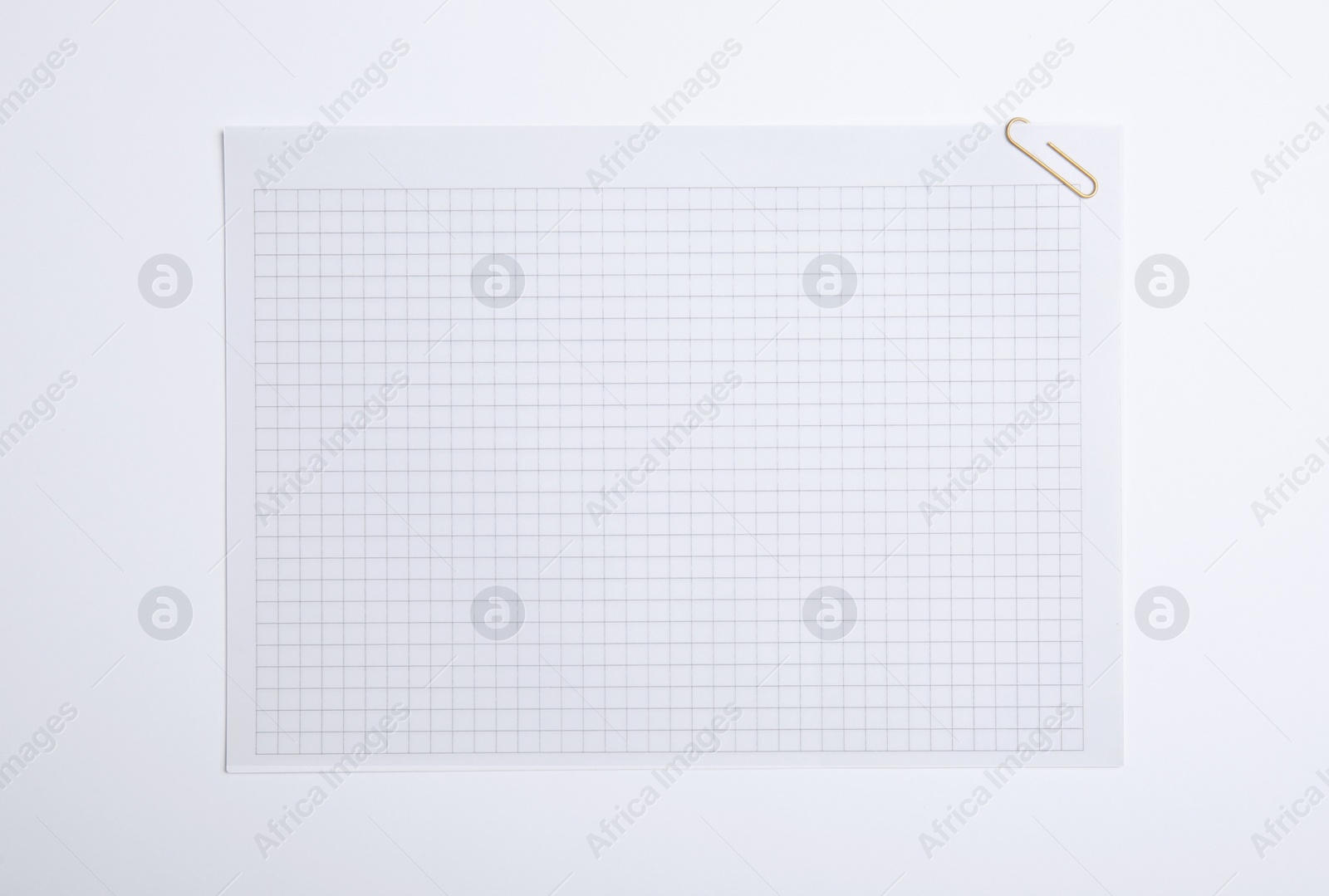 Photo of Sheet of paper with clip on white background, top view