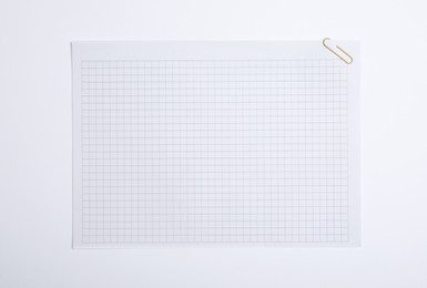 Photo of Sheet of paper with clip on white background, top view