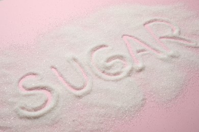 Composition with word SUGAR on pink background