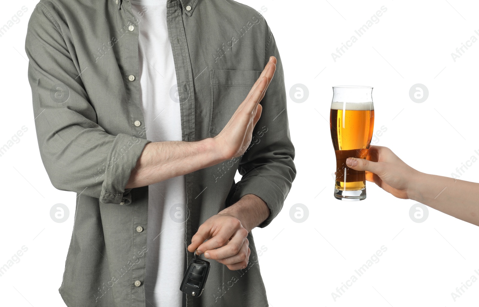 Photo of Man with car keys refusing alcohol while woman suggesting him beer on white background, closeup. Don't drink and drive concept