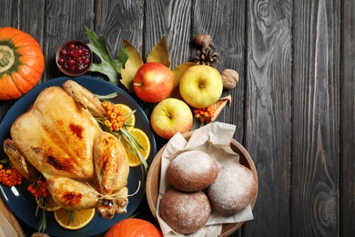 Photo of Flat lay composition with turkey on dark wooden background. Happy Thanksgiving day