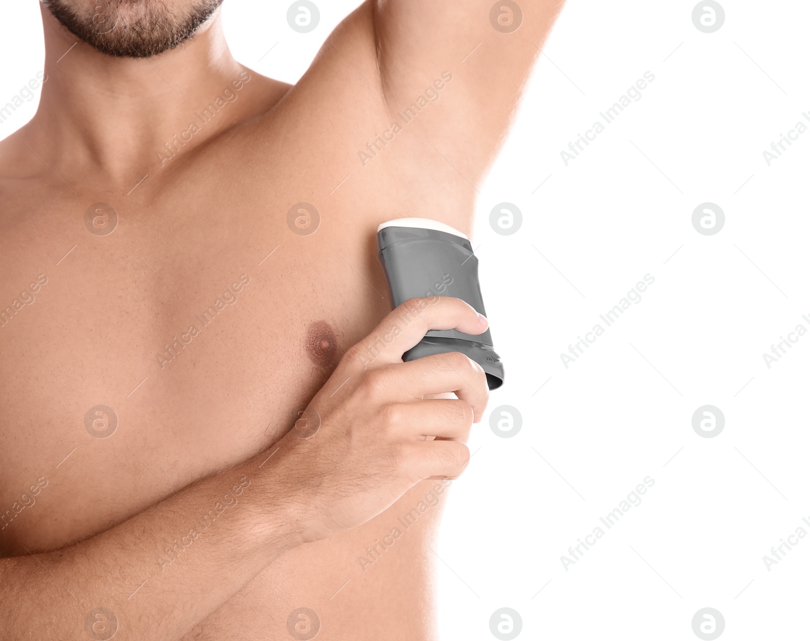 Photo of Young man using deodorant on white background, closeup. Space for text