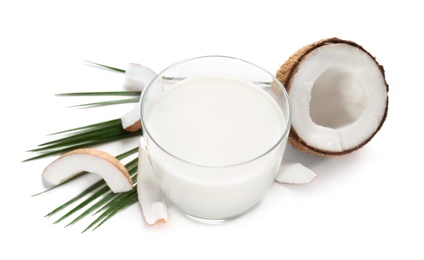 Photo of Glass of coconut milk and nuts on white background