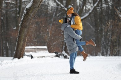 Photo of Beautiful happy couple outdoors on winter day. Space for text
