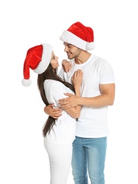 Photo of Young happy couple with Santa hats on white background. Christmas celebration