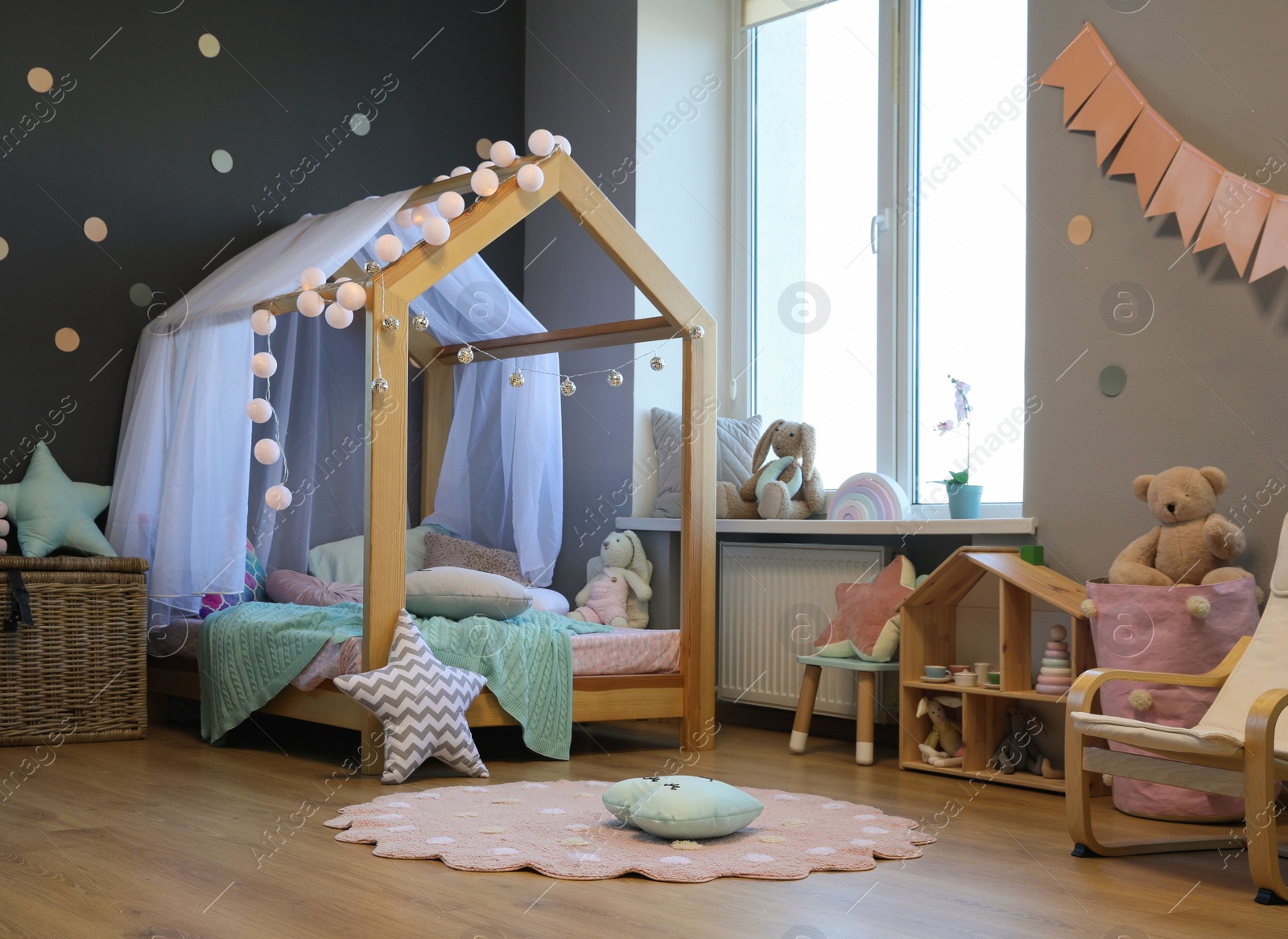 Photo of Stylish child room interior with house bed and different toys