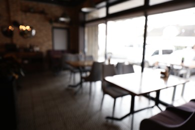 Photo of Blurred view of stylish modern cafe interior with bokeh effect