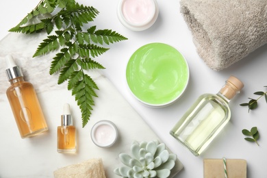 Flat lay composition with different body care products on white background