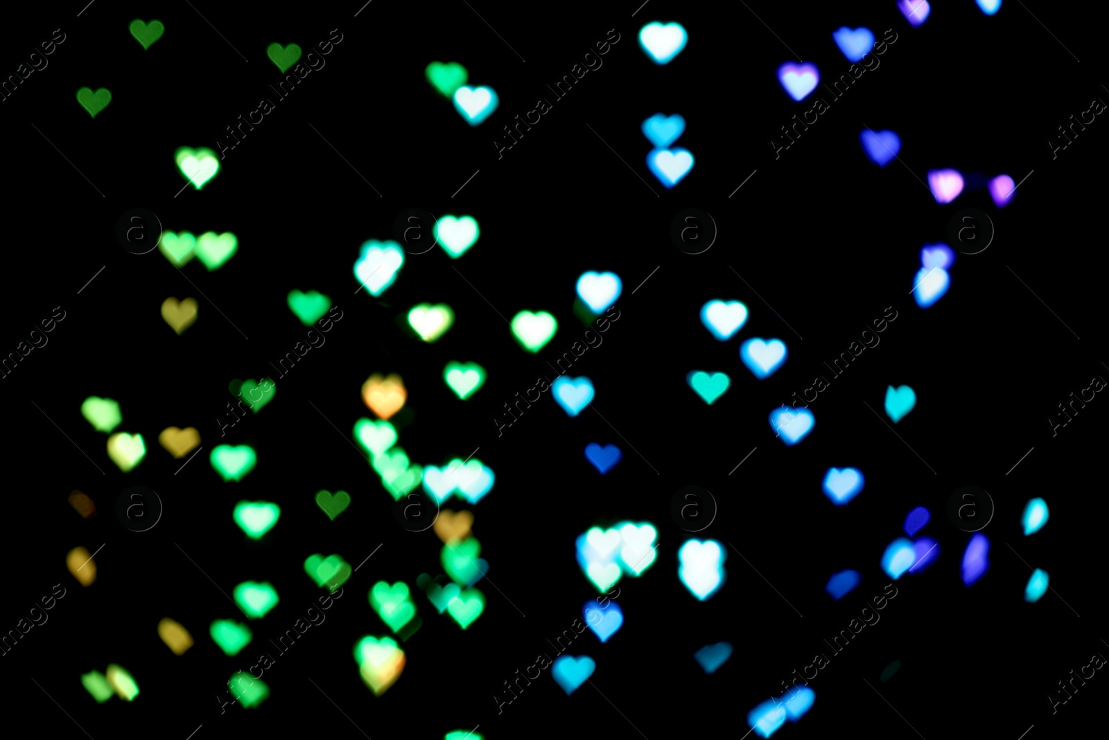 Photo of Blurred view of heart shaped lights on black background. Bokeh effect