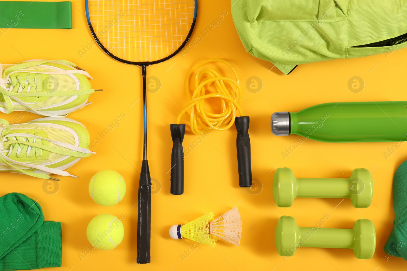 Photo of Different sports equipment on yellow background, flat lay