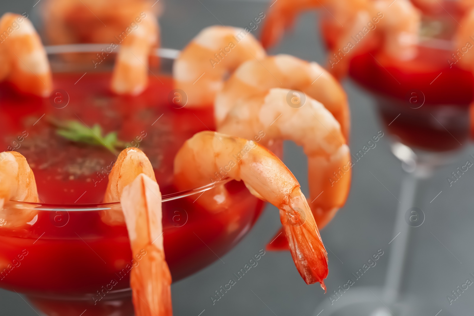 Photo of Delicious shrimp cocktail with tomato sauce, closeup