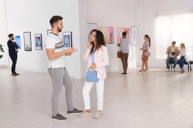 Photo of Happy couple at exhibition in art gallery