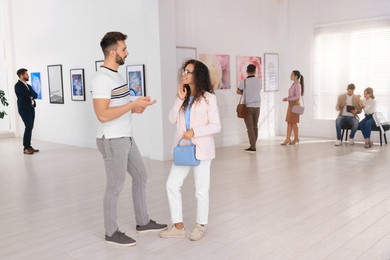 Happy couple at exhibition in art gallery