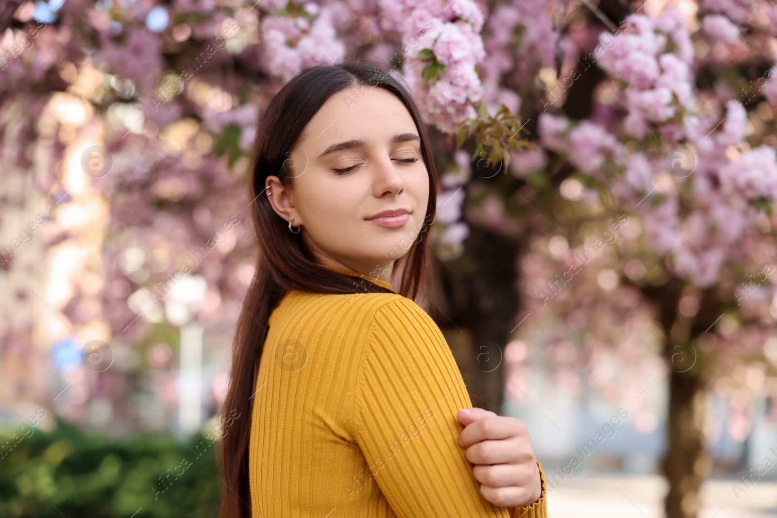 Photo of Beautiful woman near blossoming tree on spring day