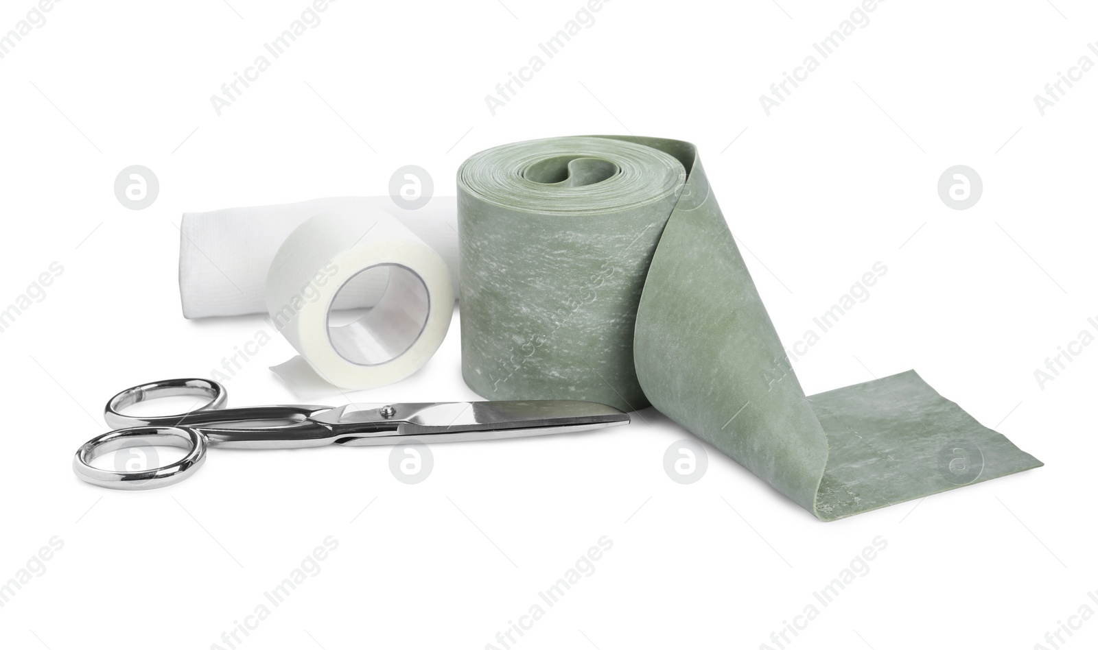 Photo of Medical bandage rolls, sticking plaster and scissors on white background