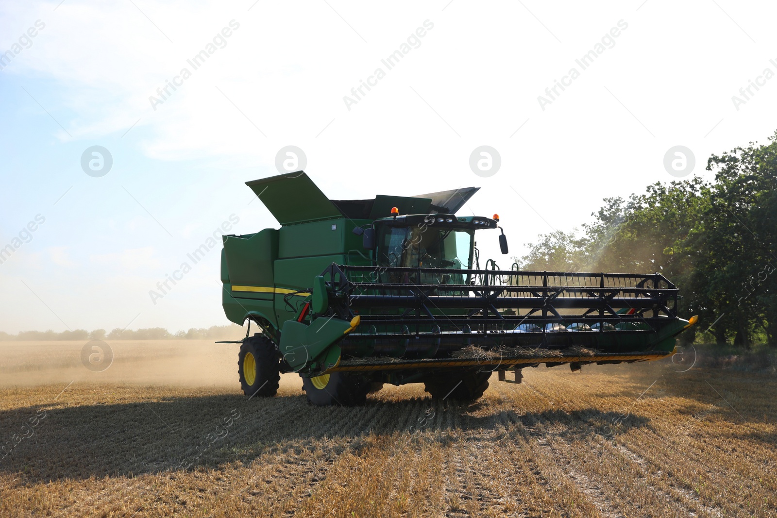 Photo of Modern combine harvester in field. Agricultural industry