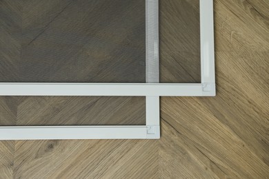 New window screens on wooden floor, flat lay