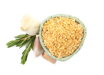 Photo of Bowl of granulated dry garlic and rosemary on white background, top view