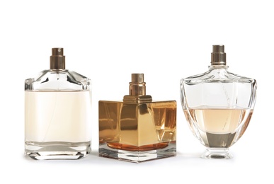 Different perfume bottles on white background