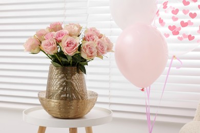 Photo of Beautiful bouquet of rose flowers in vase and air balloons in room. Happy birthday