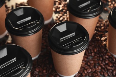 Coffee to go. Many paper cups and roasted beans on table, closeup