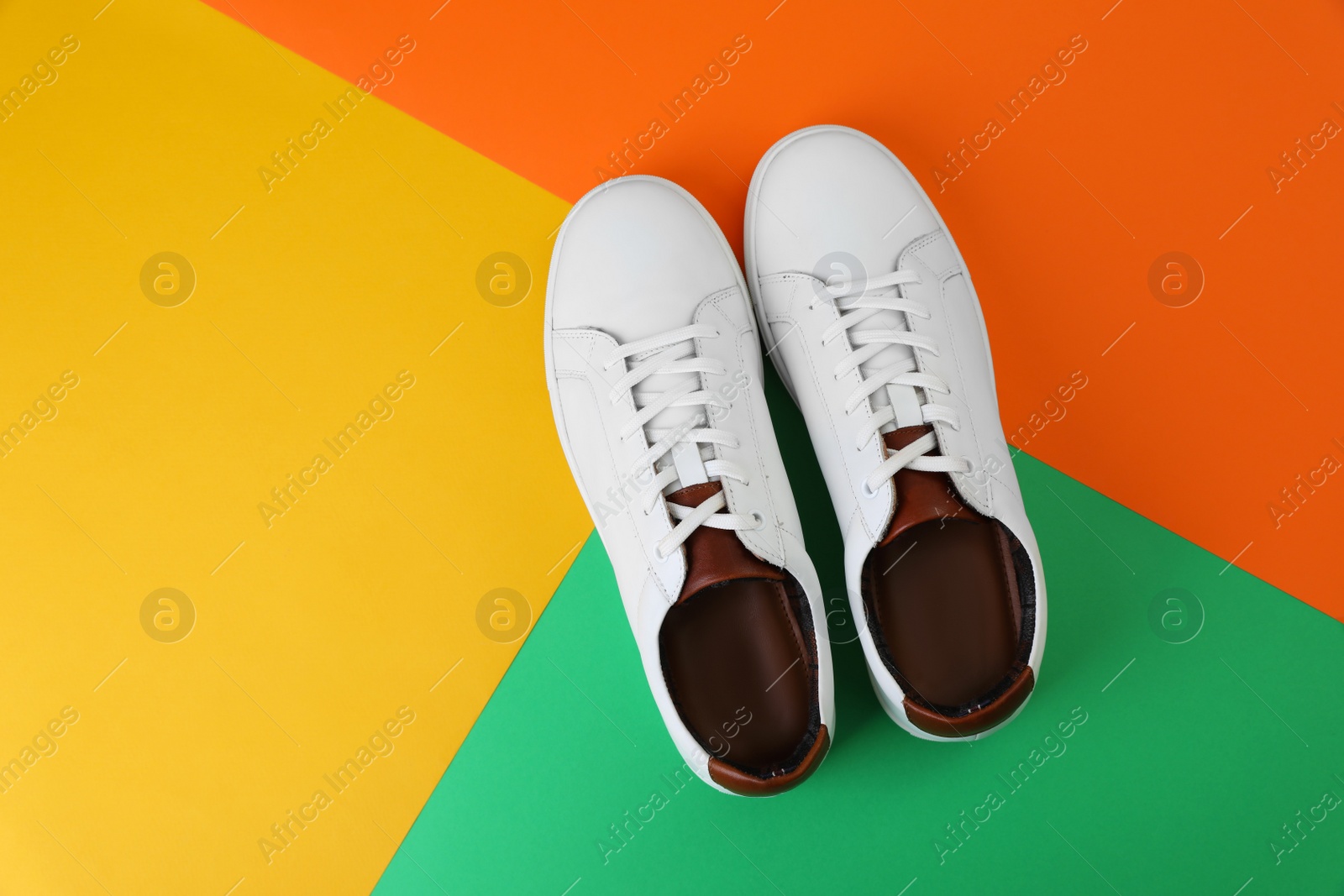 Photo of Pair of stylish sports shoes on color background, flat lay. Space for text