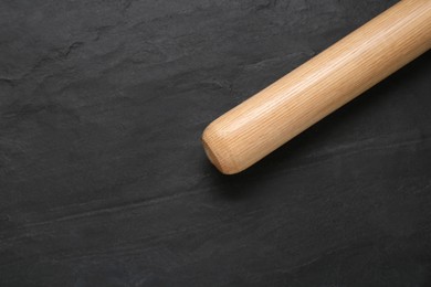 Photo of Baseball bat on black background, top view with space for text. Sports equipment