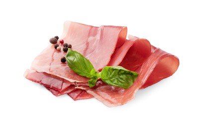 Photo of Slices of delicious jamon, spices and basil isolated on white