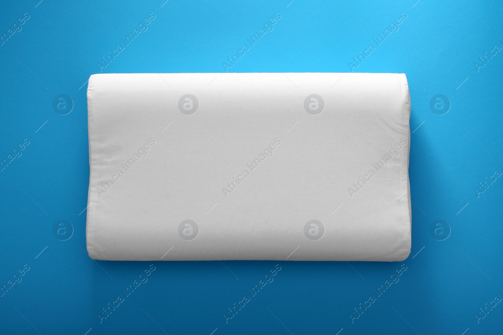 Photo of Soft bed pillow on color background, top view