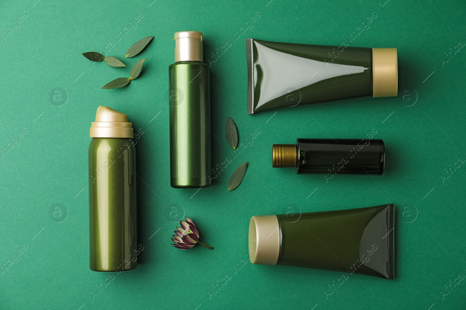 Photo of Flat lay composition with cosmetic products on green background