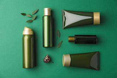 Photo of Flat lay composition with cosmetic products on green background