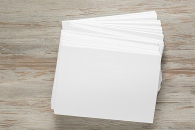 White paper sheets on wooden table, top view