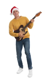 Photo of Man in Santa hat playing electric guitar on white background. Christmas music