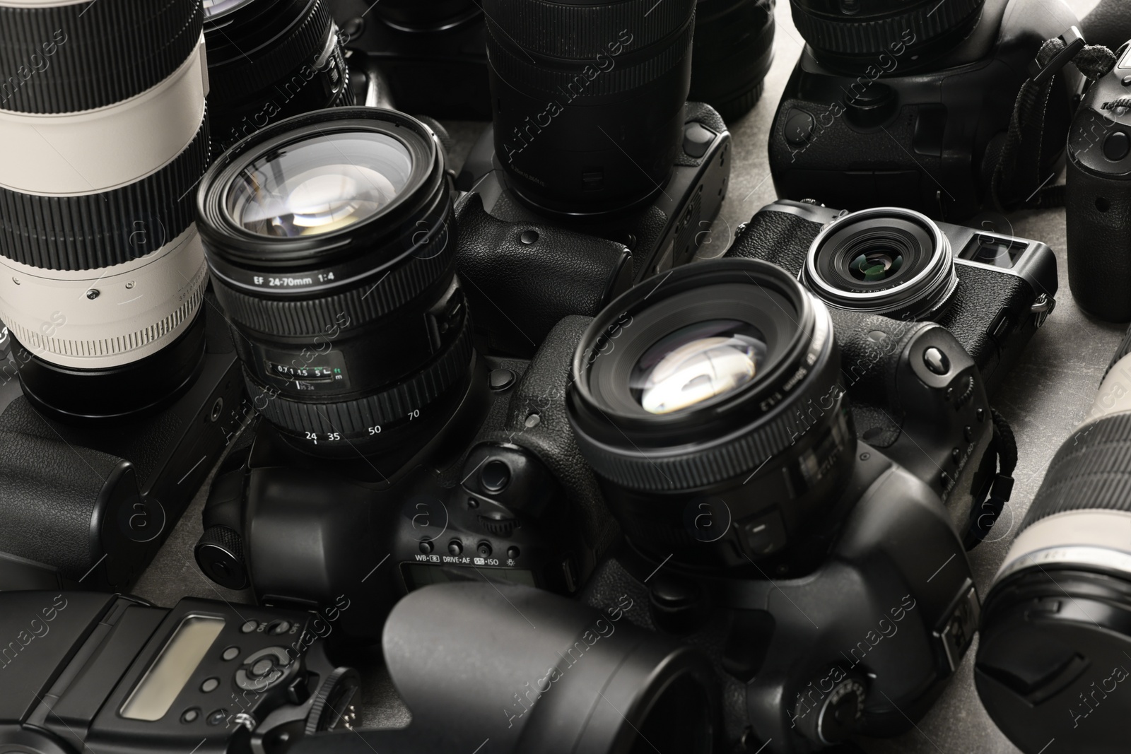 Photo of Modern cameras on table, closeup. Professional photography equipment