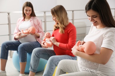 Photo of Group of pregnant women at courses for expectant mothers indoors