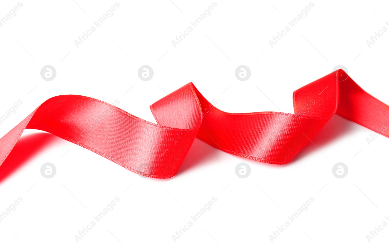 Photo of Simple red ribbon on white background. Festive decoration