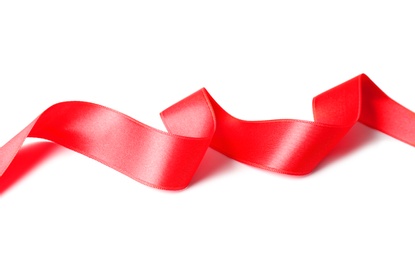 Simple red ribbon on white background. Festive decoration