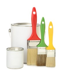 Paint cans and brushes on white background