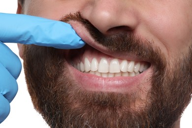 Man showing healthy gums on white background, closeup