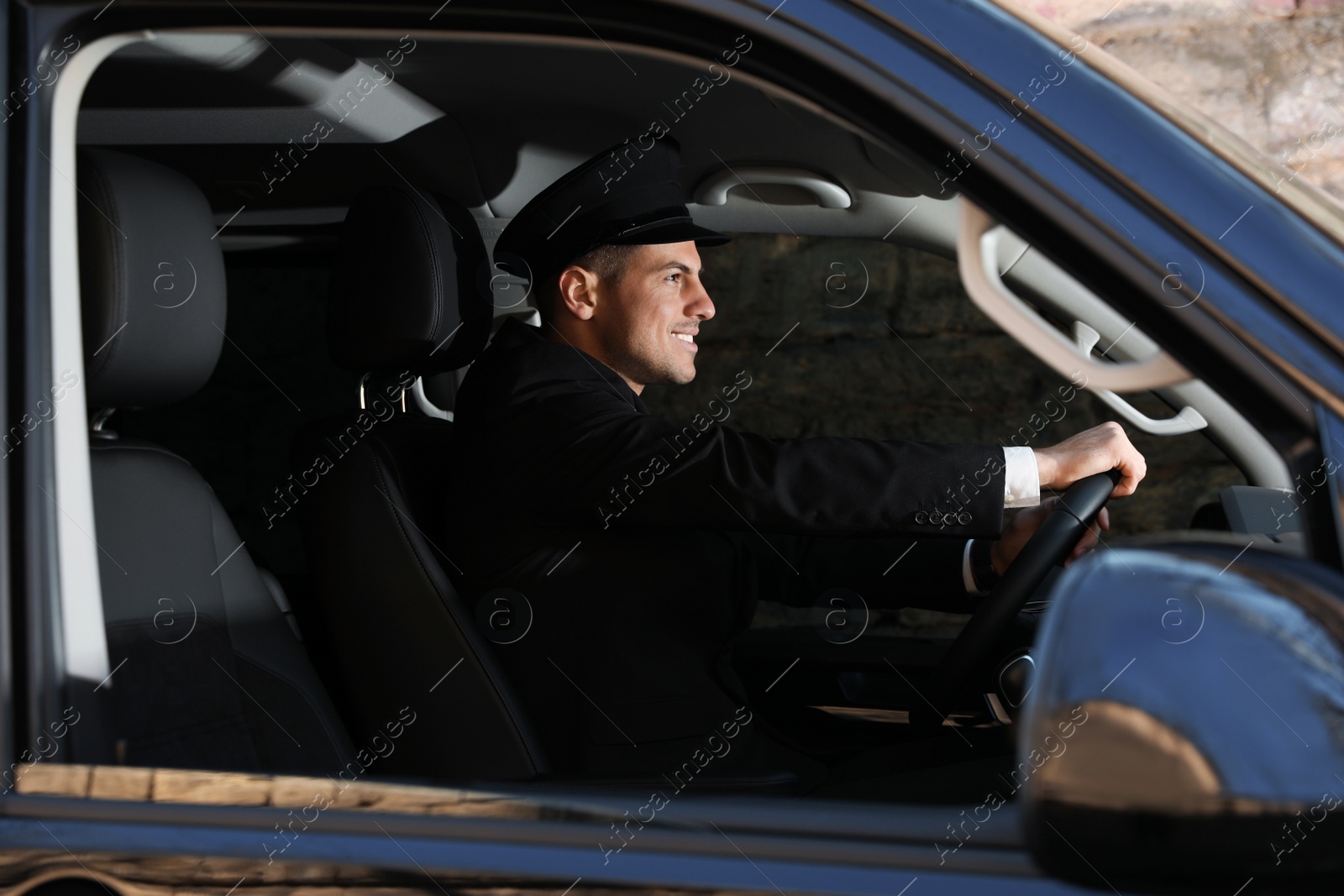 Photo of Professional driver in luxury car. Chauffeur service