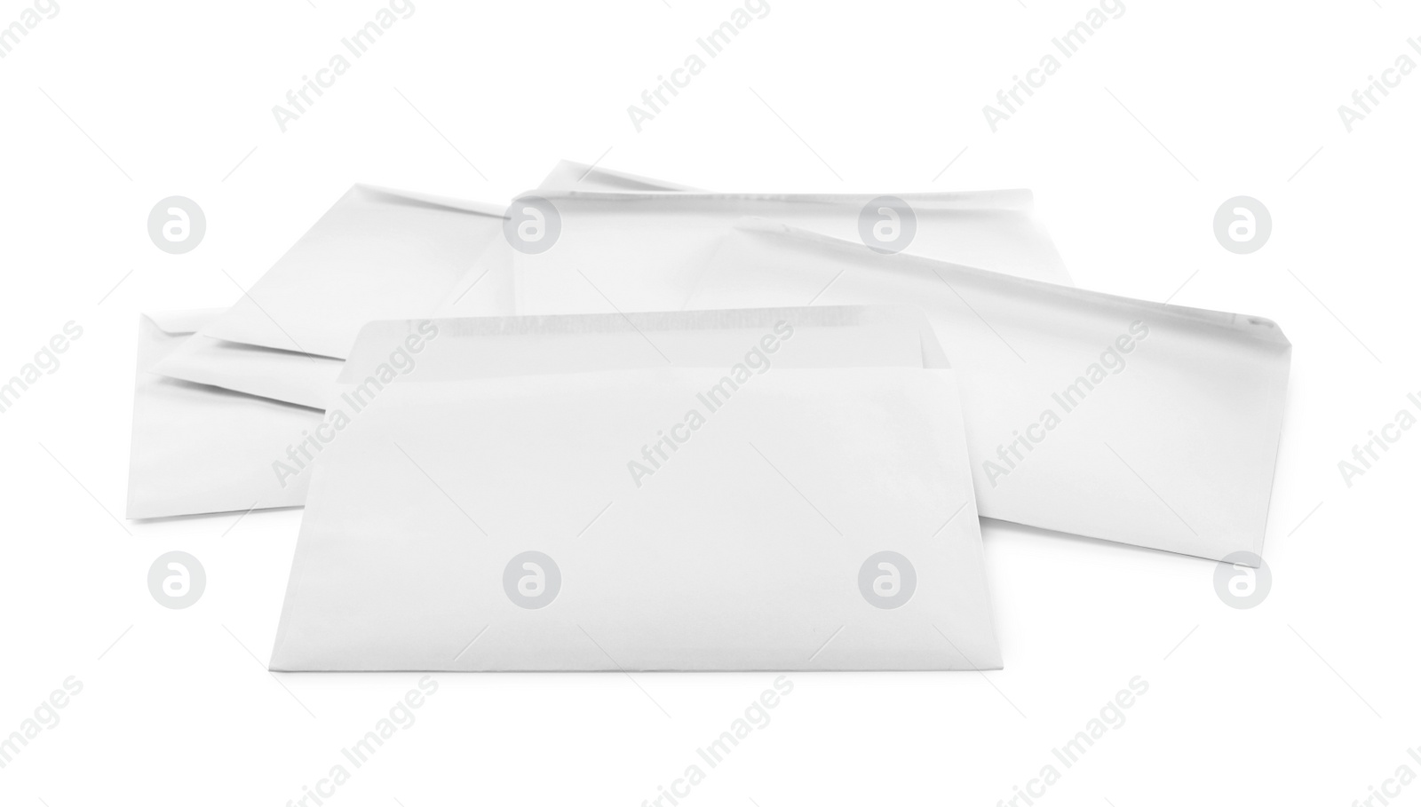 Photo of Heap of paper envelopes on white background