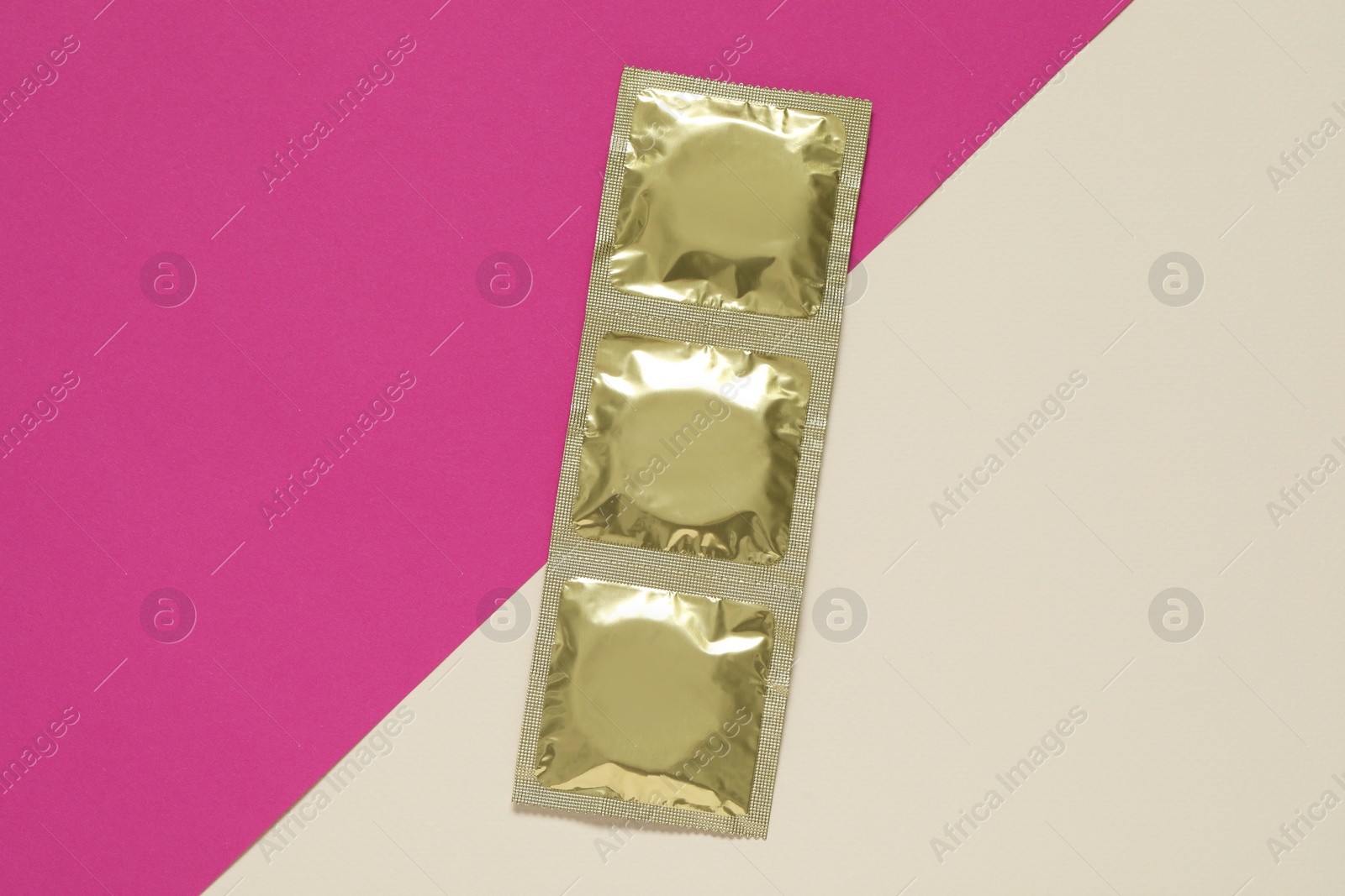 Photo of Condom packages on color background, flat lay. Safe sex