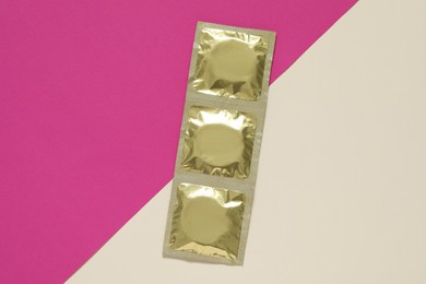 Photo of Condom packages on color background, flat lay. Safe sex