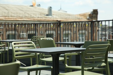 Photo of Observation area cafe. Tables and chairs on terrace against beautiful cityscape