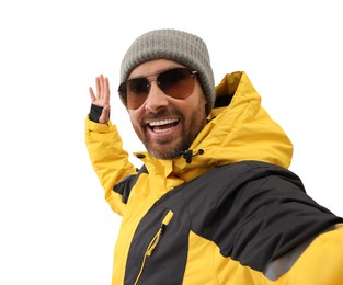 Smiling man in hat and sunglasses taking selfie on white background