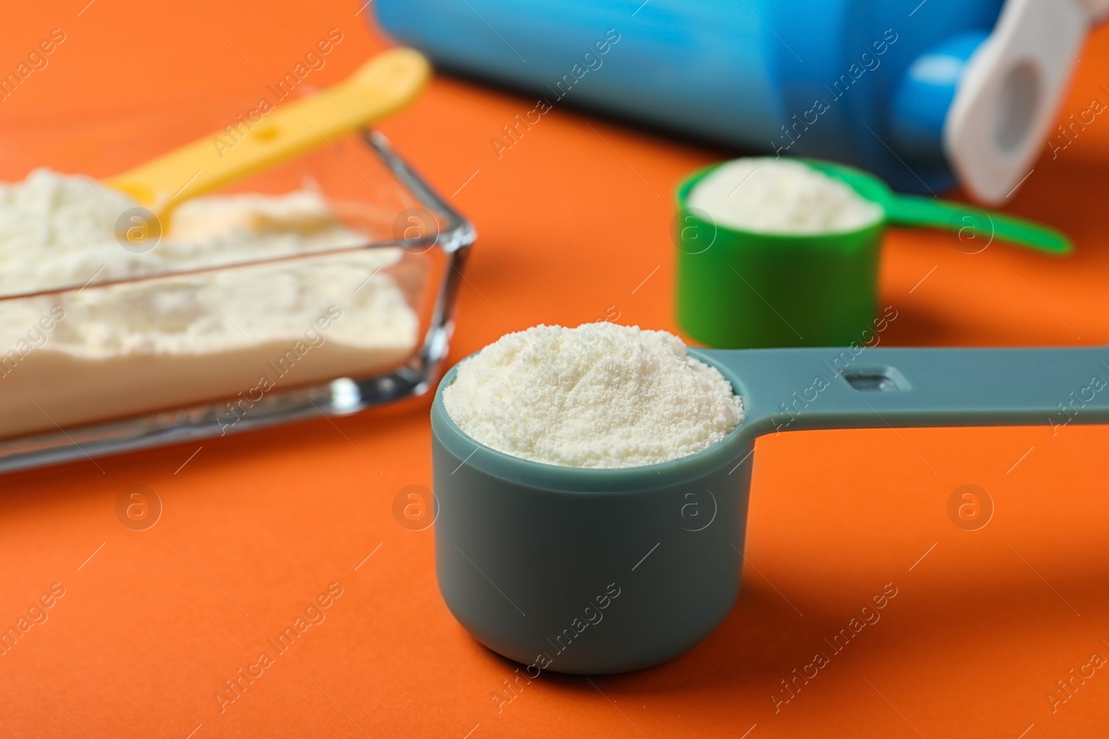 Photo of Composition with protein powder in measuring scoop on table